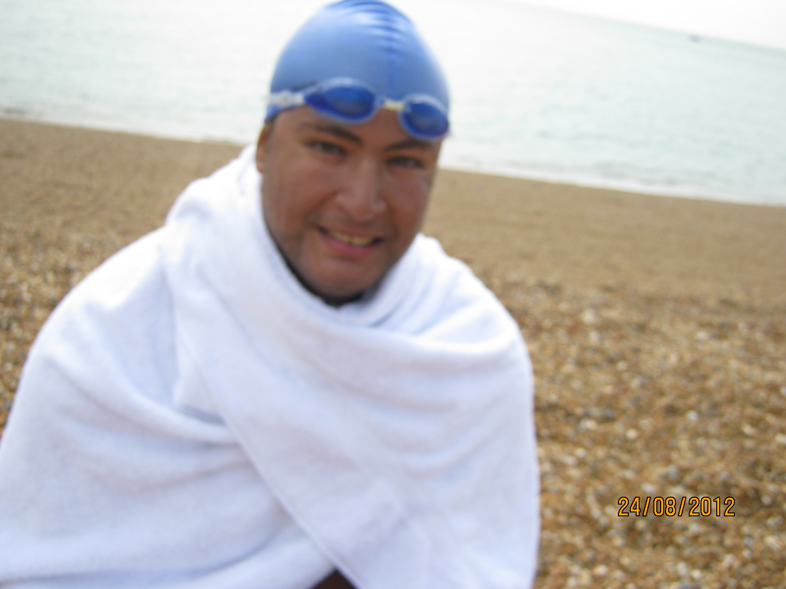 Ahmed Nasef in a swim cap on the beach