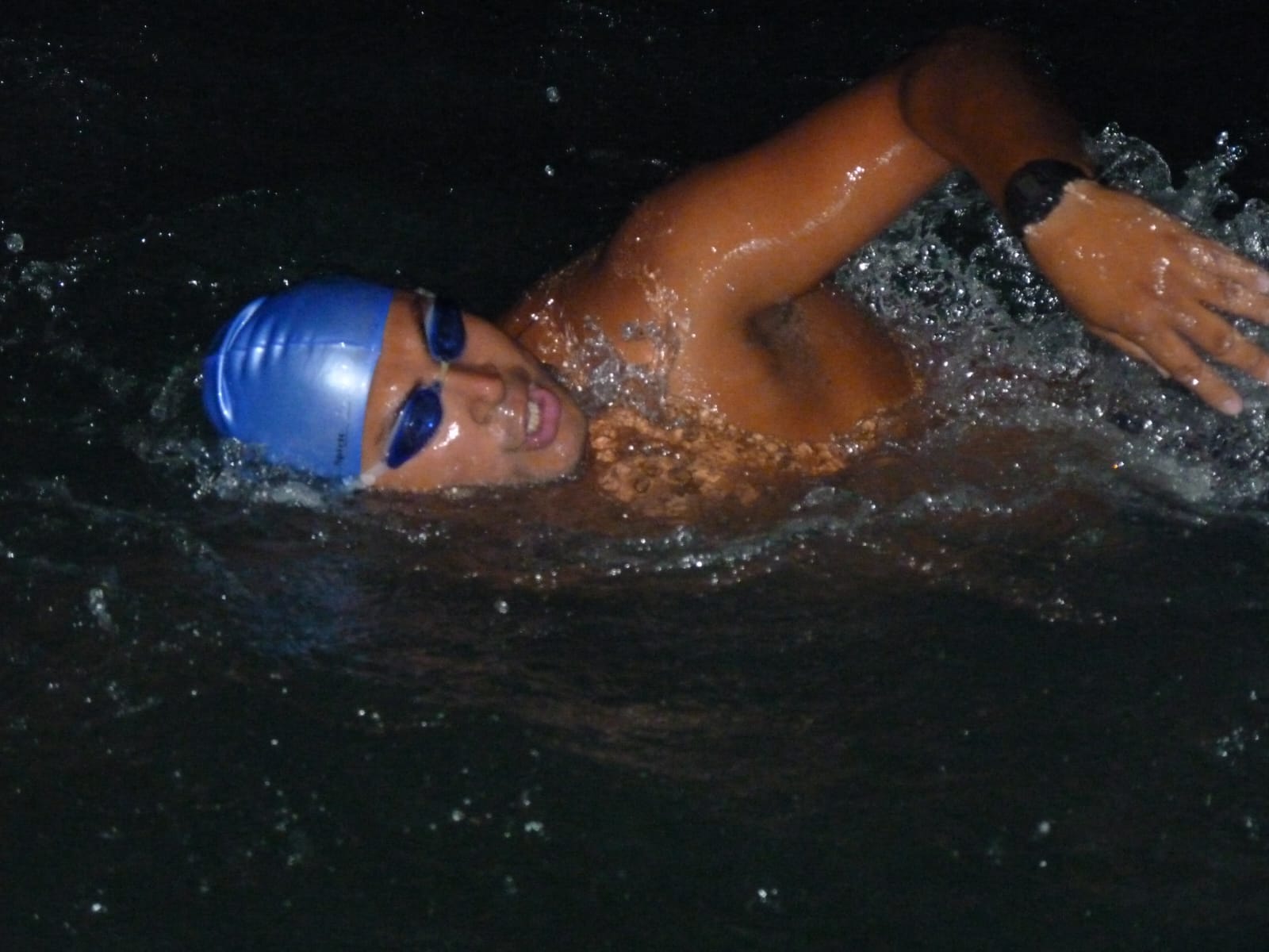Ahmed Nasef swimming in open water at night during the Channel crossing.