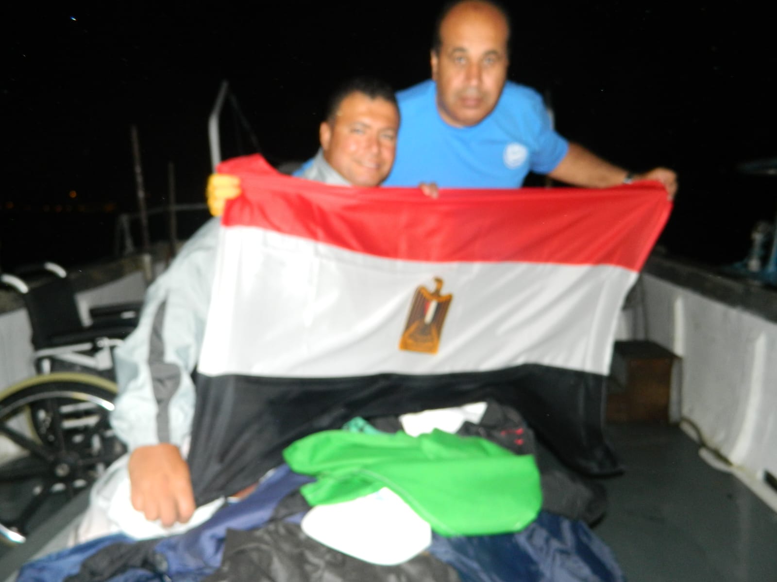 Ahmed Nasef with the Egyptian flag alongside the crossing support team.